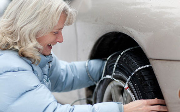 Woman Installing Tire Chains